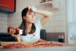 
Unhappy Clumsy Woman Staining her Shirt with Ketchup . Tired woman having a messy accident while eating pizza
