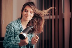 
Happy Woman Using a Hair Dryer on her Wet Long Hair
Lady taking care of herself pampering and grooming her hair
