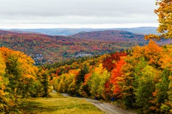View over the surroundings hills and meadows of Mont-Tremblant during Autumn, Quebec, Canada