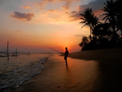 A lone fisherman at sunset, Thalpe Beach, Southern Province, Sri Lanka