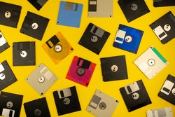 Floppy disk 3.5 inch. The diskettes 3 2 are a technology icons of de decade of 80s. Retro, vintage and colourful computer diskette. Yellow background.
