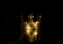 low key image of beautiful queen (or king) crown over wooden table. vintage filtered. fantasy medieval period. Selective focus. Colorful backlight