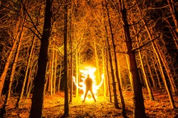 Burning man in the forest. Freezelight