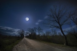 Beautiful night landscape of big full moon rising over the mountain road with hill and trees, mystical concept. Azerbaijan