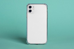 White iPhone 11 in clear silicone case back view isolated on green background, phone case mock up iPhone 12