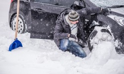 Winter, people and car problem concept. Man stuck in the snow. Mutual aid. Winter problem. transportation, winter and transportation concept