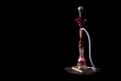 close-up. Hookah with a glass flask and a metal bowl hookah without smoke. Black background. Front view