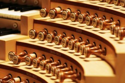 Closeup of organ knobs used for changing the voice of pipe organ sound. (very selective focus of depth)