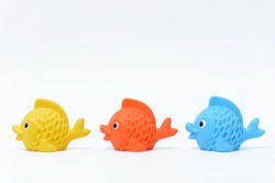 Multi-colored rubber toy fish on a white background