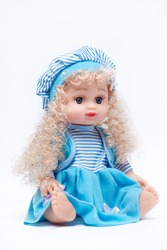 Baby doll in blue dress on white background