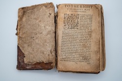 A Tattered Ancient English Book Sits Open. 
