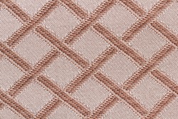 Background from a sample of furniture fabric brown and beige in macro. Cloth with a classic pattern in the form of crossed lines for upholstery of a sofa close-up.