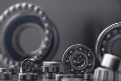 Steel bearing set. Ball radial and tapered plain bearings for mechanical engineering, heavy equipment and machine tools close-up. Spare parts in the form of round bearings of different sizes.