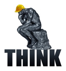 Rodin's The Thinker with a work helmet and inscription Think