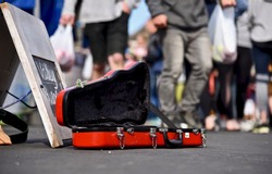 Violin case opens for donating money and coins on street, Buskers performing arts in public for money.