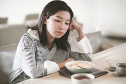 Asian young woman eating food