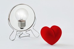 Heart looking in the mirror and seeing itself as a light bulb - Concept of dualism heart and mind, emotion and reason