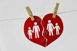 Broken heart with family joined with safety pin and attached on clothesline - Concept of saving marriage and family