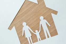 Paper cut of family and house