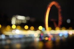 Blur image bokeh of London Eye, or the Millennium Wheel, is a cantilevered observation wheel on the South Bank of the River Thames in London, United Kingdom at night.