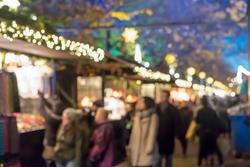 Blurred image bokeh of People walking, shopping at Edinburgh Christmas Market. New Year.