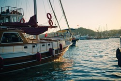 Yachts and boats docked on pier in yacht club in marina bay in Bodurm Turkey. Sunset time