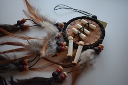 Dreamcatcher with feathers and ornaments Native american legend history bad dreams will be deterred by the bead in the feathers will attract good dreams