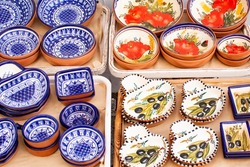 A collection of colorful Portuguese ceramics, local handicrafts from Portugal. Ceramic plates in Portugal. Colorful vintage ceramic plates in Evora