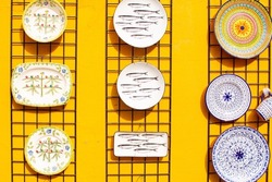 A collection of colorful Portuguese ceramics, local handicrafts from Portugal. Ceramic plates in Portugal. Colorful vintage ceramic plates in Evora