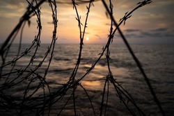 Anti-piracy razor wire at sunset