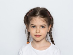 Portrait of a beautiful little girl in a white T-shirt