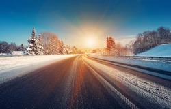 Asphalt road in snowy winter on beautiful frosty sunny day