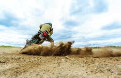 Dust splash from enduro motocycle race. Motocross bike in a race representing concept of speed and power in extreme man sport