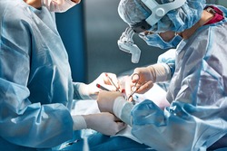 Rhinoplasty men, the surgeons gloved hands hold the instruments during nose surgery Doctor in gloves holds medical instrument during rhinoplasty