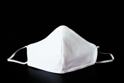 Cloth white mask isolated on black background - for prevent dust (PM 2.5), 
disease (Coronavirus or COVID-19).