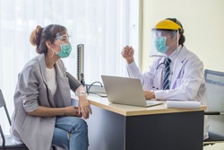 Doctor wears a mask to prevent the patient's saliva from wearing a mask, answering questions about the history of the patient infected with Corona virus covid19.Healthcare  concept.
