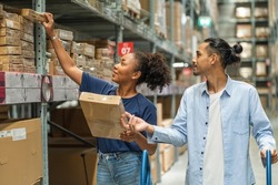 Self-service concept: African American customers go shopping with their Asian husbands and families to pick up comfortable home furnishings in a warehouse.