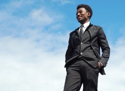 young man portrait blue sky suit and tie standing businessman leader low angle view