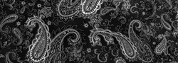 Paisley black-white pattern on a black background. decorated the bandanas of cowboys and bikers popularized by The Beatles, ushered in the era of hippies and became the emblem of rock and roll.