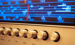 Close-up of radio display. Glowing radio with the marker running through the different stations and frequencies