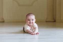 Cute 6 months Baby girl is lying on the floor