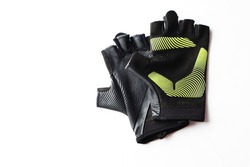 Fitness gloves use for training at gym or fitness center isolated in white background, workout routine protecting hands when lifting weight, has copy space, sport equipment, healthy lifestyle concept.