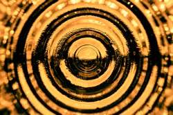Concentric golden contrast circles radiating from the center with bokeh in the foreground
