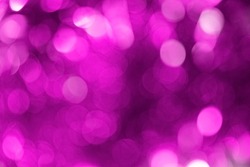 Blurry purple background with defocused bokeh circles from a Christmas garland