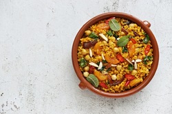 Vegan Moroccan Bulgur with Chick Peas, spinach, dried apricots and date fruit. Traditional African Tajine dish. Flat layot