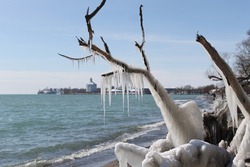 View of Oshawa Harbour shoreline with winter ice formations in Oshawa, Ontario, Canada