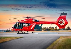 Red color helicopter. Great photo on the theme of air medical service, air transportation,  air ambulance,  fast city transportation or helicopter tours. 