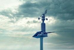 Automatic weather station, with a weather monitoring system. Against the background of a gray sky with clouds. soft focus.