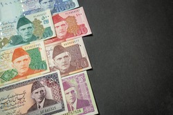 Made the Pakistani Rupee (PKR) banknotes from Pakistan as the background on the black paperboard