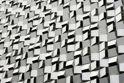 Anodized aluminium panels forming geometric cheese grater pattern on exterior of multi storey car park